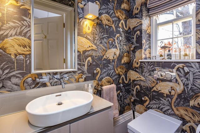 Bold bird wall coverings dominate one of the bathrooms.