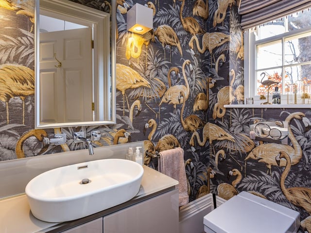 Bold bird wall coverings dominate one of the bathrooms.