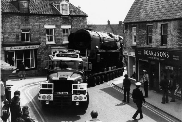 April 1980 and a trailer with its unusual load manoeuvres through Pickering's narrow streets. The rusting Taw Valley, an ex Southern Railway engine rescued from a scrap yard at Barry, South Wales, was on the last stage of a 25mph journey by road to Pickering to join the rolling stock of the North Yorkshire Moors railway. Bert Hitchen brought 100 tonne steam locomotive for his wife Elizabeth as a birthday present. The  copuple would spend their weekends for the next four years helping to restore the engine at a cost of about £30,000.