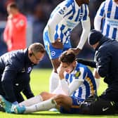BRIGHTON, ENGLAND - APRIL 02: Jakub Moder of Brighton & Hove Albion receives medical treatment during the Premier League match between Brighton & Hove Albion and Norwich City at American Express Community Stadium on April 02, 2022 in Brighton, England. (Photo by Warren Little/Getty Images)