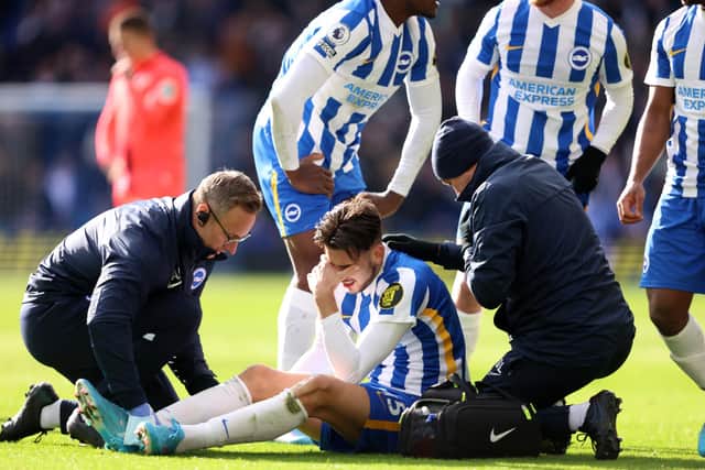 BRIGHTON, ENGLAND - APRIL 02: Jakub Moder of Brighton & Hove Albion receives medical treatment during the Premier League match between Brighton & Hove Albion and Norwich City at American Express Community Stadium on April 02, 2022 in Brighton, England. (Photo by Warren Little/Getty Images)