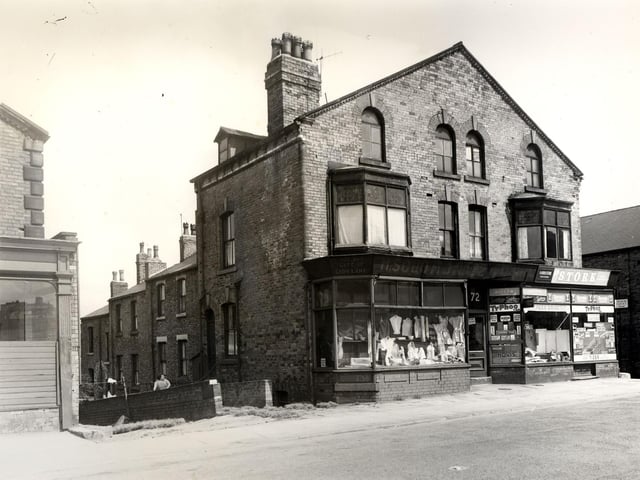 Camp Road is on the left edge, then Back Glover Street. Next, 72 Camp Road has a window display of mainly ladies clothes and material. Faded lettering above the shop reads 'H. Solomon, est.1902, late of Lady Lane'. It may have referred to be previous owner of the shop. To the right, 70 is the business of R. Addlestone, grocer. Crawford Street is next on the right edge. Pictured in July 1958.