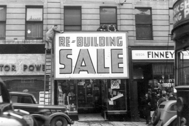 Stone's Radio shop with signs being put up which state 'Re-building sale' in January 1939.