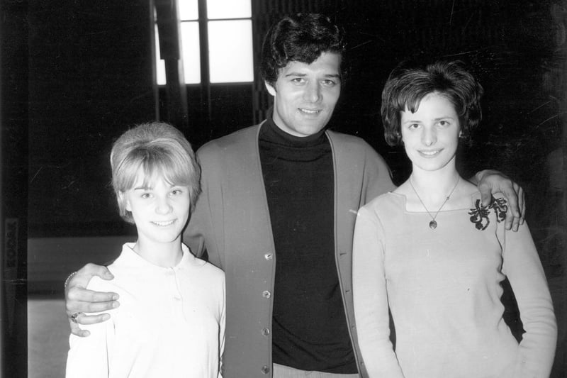 Pop singer Eden Kane is photographed with two girls, making a personal appearance at the Silver Blades skating rink in May 1965. Born Richard Sarstedt he had a number 1 hit with Well I Ask You and a further top ten hit with Boys Cry in 1964.