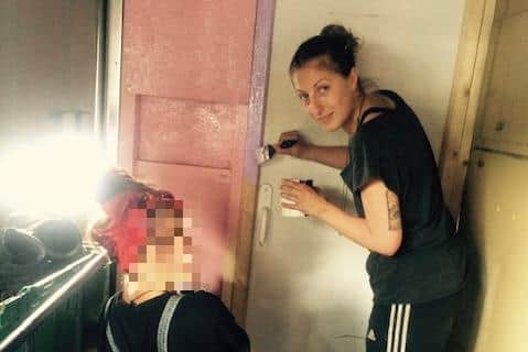Emily volunteered at a refugee camp in Calais. This is her painting the new women and children's centre bus which was used after a tent was burnt down.