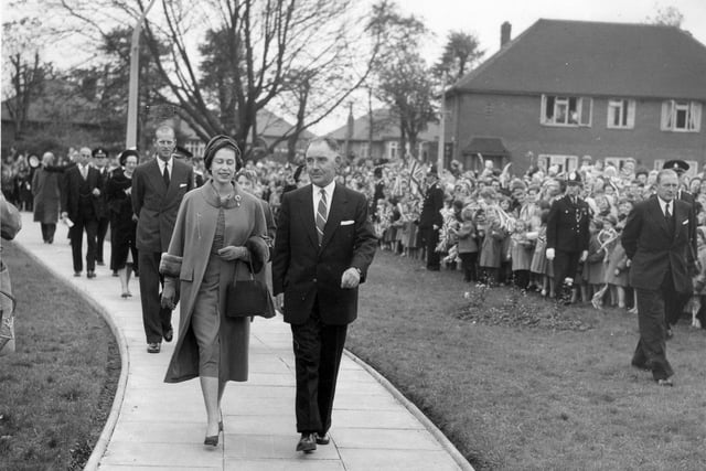 Her Majesty Queen Elizabeth II, escorted by Councillor Albert King, Chairman of the Welfare Services Committee, with the Duke of Edinburgh following behind, arrive at Brackenhurst Hostel on Fieldhouse Drive in October 1958. The royal couple were there to officially open this care home for the elderly, one of many stops they made during a two-day visit to Leeds. The hostel had since been demolished and private flats have been built on the site.