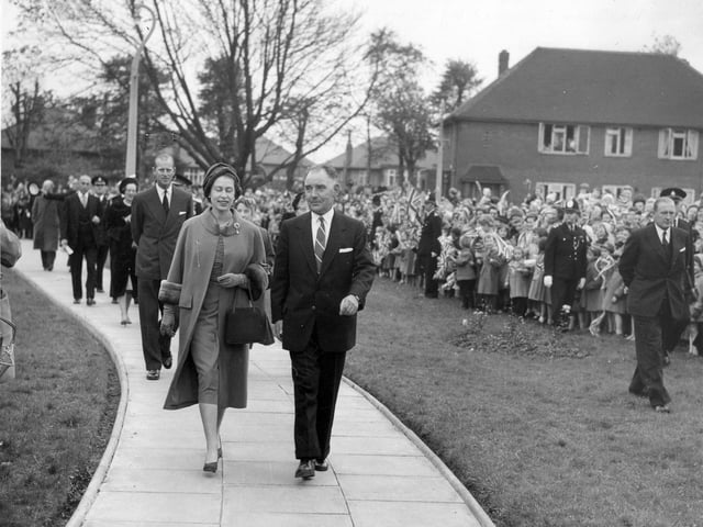 Her Majesty Queen Elizabeth II, escorted by Councillor Albert King, Chairman of the Welfare Services Committee, with the Duke of Edinburgh following behind, arrive at Brackenhurst Hostel on Fieldhouse Drive in October 1958. The royal couple were there to officially open this care home for the elderly, one of many stops they made during a two-day visit to Leeds. The hostel had since been demolished and private flats have been built on the site.