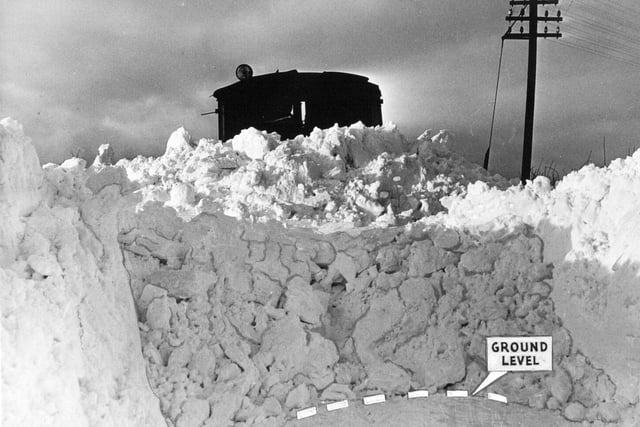 A giant snowplough breaks through the road to Thixendale in January 1960.