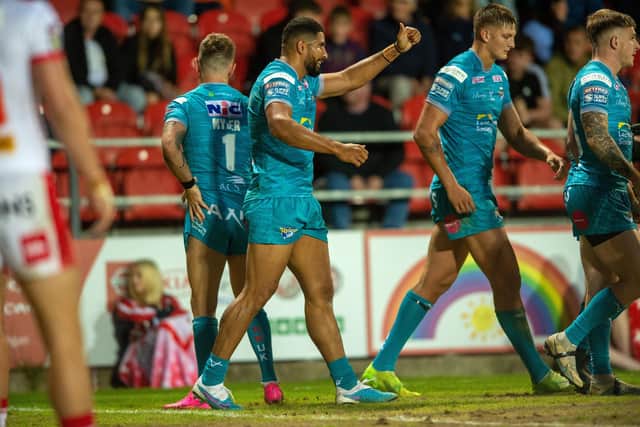 Nene MacDonald, second from left, celebrates scoring for Rhinos against St Helens.  Picture by Bruce Rollinson.