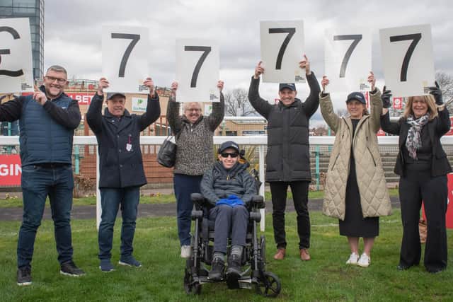 Rob Burrow receives a donation of £77,777 from The Good Racing Company at Doncaster Races. L-R Barrie McDermott, Mark Newton, Irene Burrow, Rob Burrow, Graham Newton, Lindsey Burrow, Sharon Newton. Picture by Nigel Kirby.