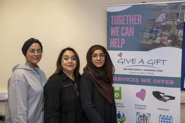 Rifhat Malik, director of Give A Gift, has help from colleagues Hana Agha and Zobi Barok. Image: Tony Johnson