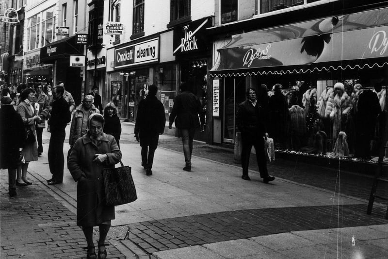 Christmas shoppers walk down Commercial Street in 1983. Shops seen include Crockatt Cleaning, Tie Rack and Dyson Furriers.