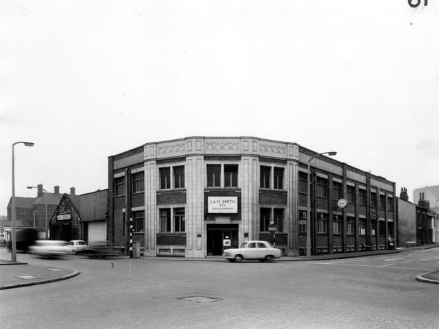 Whitehall Road runs from the left edge to the bottom right corner of this view from March 1965 with Spence Lane running from the bottom left corner to the right edge. In the centre to the right edge. In the centre is Corner House. Built around the early 20th century this building was first used as the offices of Ideal Stores Ltd. In this view it is the premises of J. and H. Smith Ltd, tools and hardware merchants.