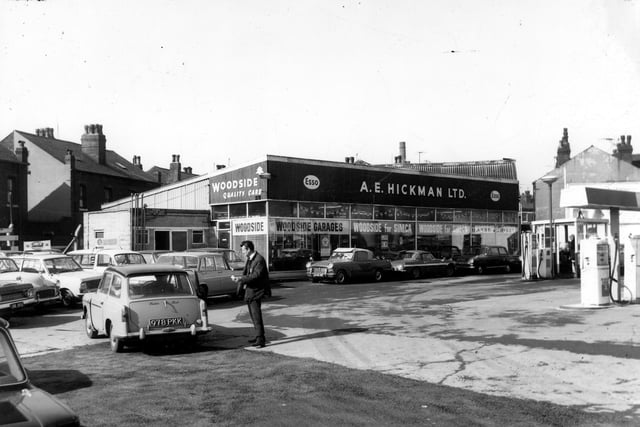 The garage premises 'Woodside' run by A. E. Hickman Ltd. The car showroom has advertisements for Simca cars. To the left a man is talking to the driver of an Austin A40 car. Petrol pumps can be seen to the right. Pictured in April 1968.