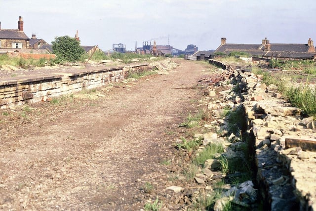 The site of Morley Top Station, where the tracks, the sleepers and the ballast have disappeared from the G. N. R. line; everything connected with the station has been dismantled including many of the flat sandstone slabs at the edge of the platforms. Tingley gasworks is still visible in the distance and by now the station looks to be ready for final clearance before starting on the new road and new buildings.