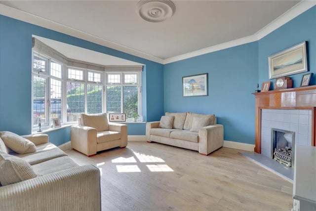 There is a separate, large bay fronted reception room, flooded with natural light and with a pleasant front aspect. It boasts a feature tall oak fireplace housing a Living Flame coal effect gas fire.