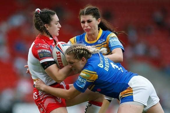 Caitlin Beevers and Elle Frain tackle Saints'  Leah Burke during Rhinos' win at TW Stadium in June. Picture by Ed Sykes/SWpix.com.