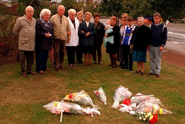 Relatives and friends of the Hickson & Welch disaster stand in silence after laying wreaths outside the chemical works at Castlefordon the fourth anniversary in September 1996.