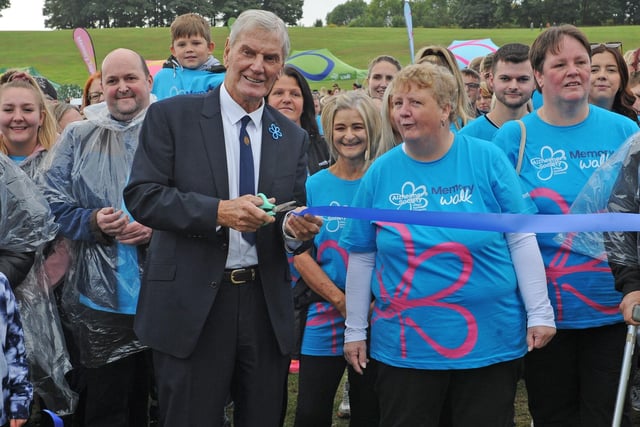 Former Leeds United player Alan Peacock cuts the tape to start the walk. (Pic: Steve Riding)