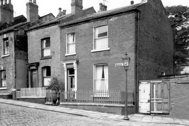 A boy enters the gate of a house on Highfield Street (perhaps to call for his friend on the way to school). Pictured in July 1964.