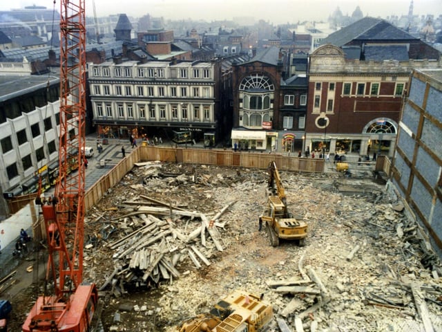 View onto the site where the 1962 Schofields store had recently been demolished. It was to be replaced by the Schofields Centre, a retail development incorporating a smaller Schofields store. Across the background Lands Lane is visible, a shopping street which runs between The Headrow and Commercial Street. The old white buildings in the background number 28 and 30 Lands Lane and is Grade II listed.