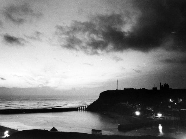 A rare moment of deep calm in old Whitby which would be soon filling with summer visitors. View of East Cliff, with The Abbey stark on the skyline at 4am from The West Cliff in May 1978.
