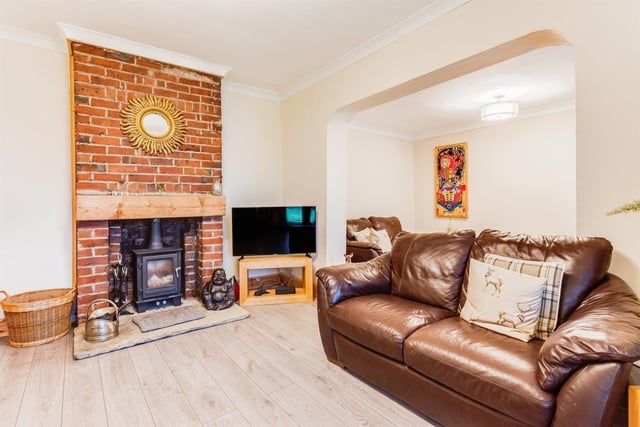 A feature brick fireplace holds a warming stove within the lounge area.