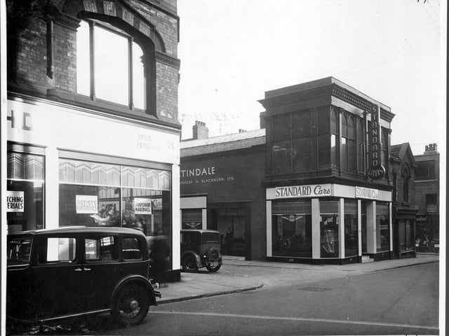 Albion Street iin September 1935. Number 126 Rex Holliday artists supplies signs in the window 'Artists materials', 'Lampshade Making'. Next junction with St Ann's Street. Numbers 120/122 garage and car showroom 'Standard Cars' Spencer Blackburn owner. The garage has cars in showroom, vehicles in the street.