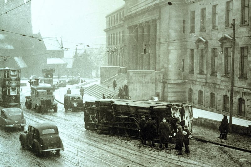 Overturned tram on a snowy day outside the University of Leeds in February 1951.