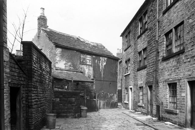 Very old properties in Ebenezer Place with a rather confusing numbering system. The central dwelling is number 1, but is perhaps number 1 Ellis Yard which is at the rear. On the right the three storey dwellings alternate with through properties addressed Lower Town Street, and only number 4 is part of Ebenezer Place (on the left of the drain pipe). Pictured in March 1960.