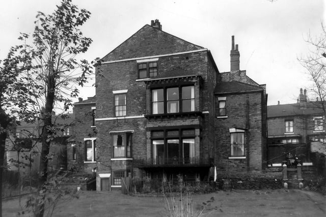 This is the rear view of 195, 197/199 Burley Road. The premises are listed as doctors surgeries, for Geoffrey Burchell, J.G.B. Platts and A. Barrett. The central portion seen here was number 197 or 199 and was separate from the original two houses. Pictured in October 1959.