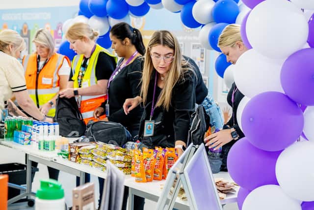 The packs contain new mobile phones with credit, toiletries, including sanitary towels, toothbrushes and toothpaste, non-perishable snacks, emergency children's items, notebooks, writing materials, a whistle, and a mini torch.