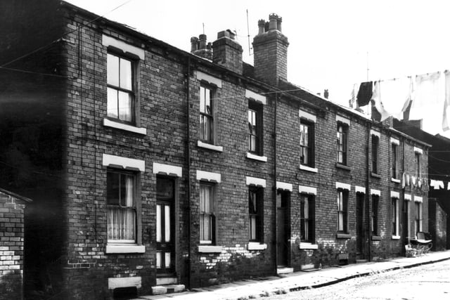 This view looks onto odd numbered back-to-back houses on Prosperity Street in June 1967. Houses are double fronted and washing lines are visible.