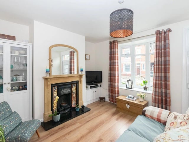 The feature fireplace, in working condition for a real fire, makes this living room an inviting place to relax and unwind.