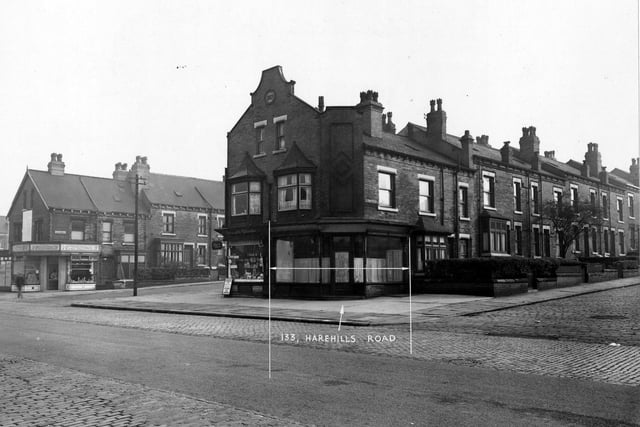 The east side of Harehills Road in September 1950. Number 133 labelled between Ashton Grove and Ashton Place. Stephenson's butchers and Craven's tobacconists. Advertisements for Lyon's ice-cream and Players Please tobacco visible.