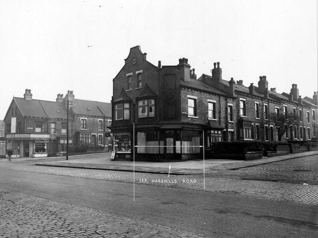 The east side of Harehills Road in September 1950. Number 133 labelled between Ashton Grove and Ashton Place. Stephenson's butchers and Craven's tobacconists. Advertisements for Lyon's ice-cream and Players Please tobacco visible.