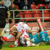 Nene Macdonald defies two defenders to score for Rhinos agianst St Helens. Picture by Bruce Rollinson.