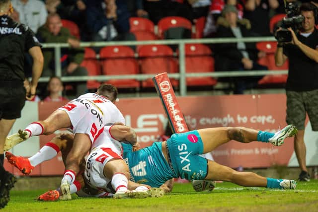 Nene Macdonald defies two defenders to score for Rhinos agianst St Helens. Picture by Bruce Rollinson.