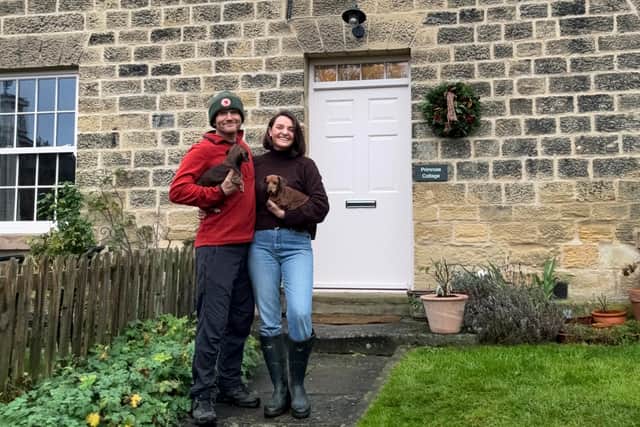 Jessica Higgins and her partner, Tim, outside their cottage on the Harewood Estate.