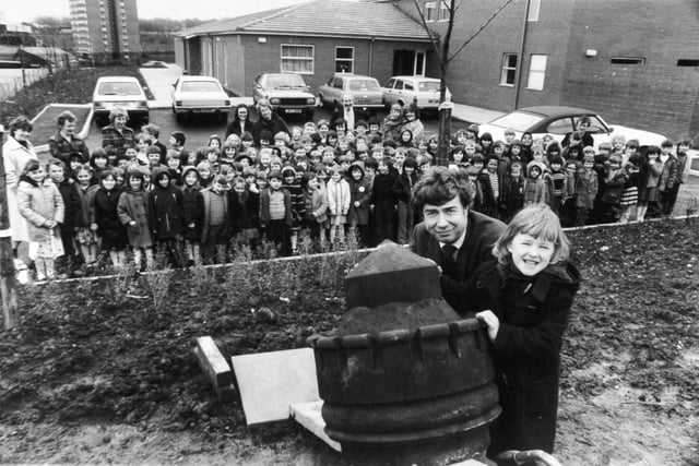 A piece of the past was planted in the grounds of brand new Castleton Primary School in March 1981. For the staff and pupils of Castleton, dubbed "the school for scandal" when it was in its Victorian Armley Road premises, now have the 100 year old castle shaped gatepost top as a keepsake. Pictured are pupil Sarah Trigg with John Creswell, of Witt, Newton and Co., stonemasons, installing the old stone on its new site, watched by staff and pupils.