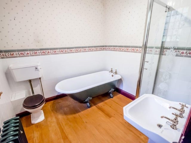A free standing roll-top bath and a separate shower cubicle form part of the bathroom suite.