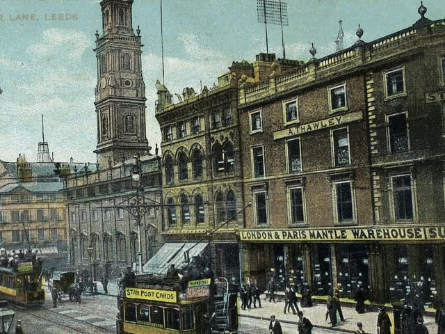 A colour tinted postcard with a postmark of August 19, 1907 showing the north side of Boar Lane. On the right is Sutton's London & Paris Mantle Warehouse with the studio of Arthur Thawley, photographer, above. Further along to the left is Holy Trinity Church then Monteith, Hamilton & Monteith Ltd. (The Grand Pygmalion), drapers.