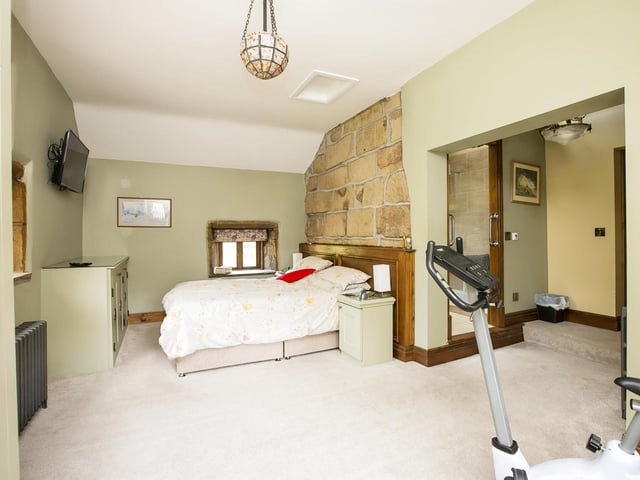 This double bedroom has open stonework to one wall.