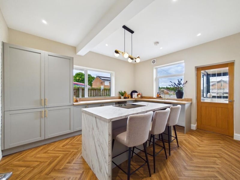 This room features a range of base units and a kitchen island. There is also an integrated electric oven and hob and space for dishwasher and integral fridge and freezer.