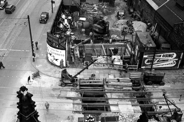 Work in progress on a sewer on Great Wilson Steet near the junction with Meadow Lane. Rose and Parkin brassfounders is in the background. Cranes are visible on the building site for a car park.  Pictured in June 1955.