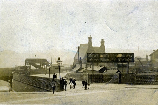 The entrance to Bramley Railway Station on Stanningley Road. A sign reads 'Great Northern Railway to Bramley Station'.