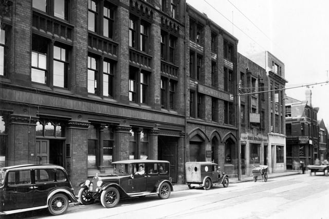 Businesses and offices on St Pauls Street in August 19327. Pictured, from left to right, number 37 is London Midland and Scottish railway offices, 41, W. Power and Son, shirt makers, Rostrum House. Lewis Hindle & Sons auctioneers, Leeds Liberal Federation, Planning Bros, confectioner manufacturer, Central Estate & business agency. Junction with Central Street can be seen with J. Louden, woollen manufacturers.