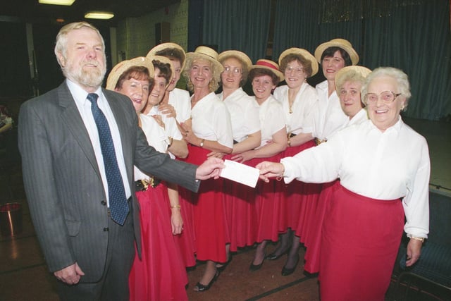 Ryhope Toppers, a Sunderland group of dancers,  raised more than £2,000 for charity. Handing over the cheque to Ernie Thompson of the the Alzheimers Society is Olive Huntley surrounded by members of the Toppers at Ryhope Workingmen's Club in 1994.
