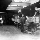 A view looking along a production line at Edward Joy & Sons Ltd, filtrate works on Kidacre Street. Drums of oil, dated March 1945, can be seen with several workers checking them.
