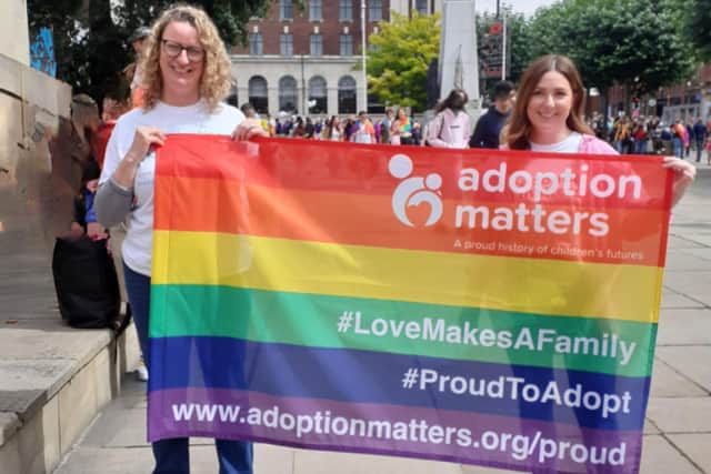 Adoption Matters parading their LGBTQ+ Pride flag.